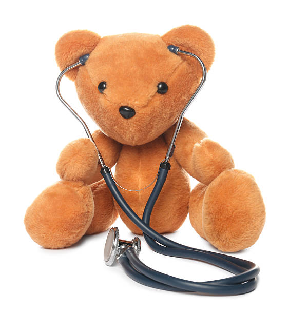 istock Pediatrics concept. Teddy bear and stethoscope isolated on white 2244604243
