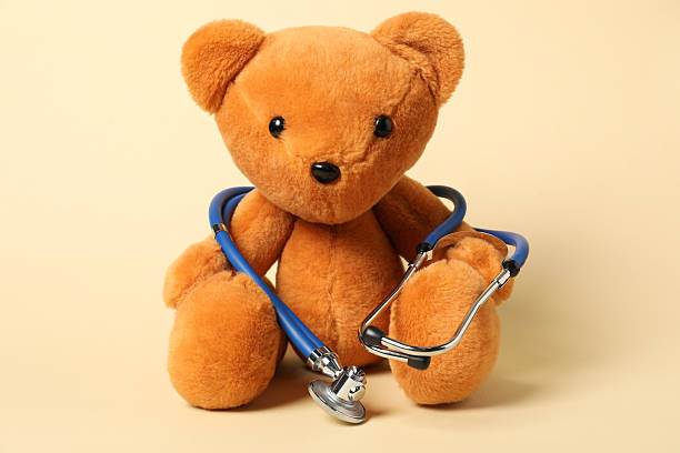 istock Pediatrics concept. Teddy bear with stethoscope on beige background 2244604958