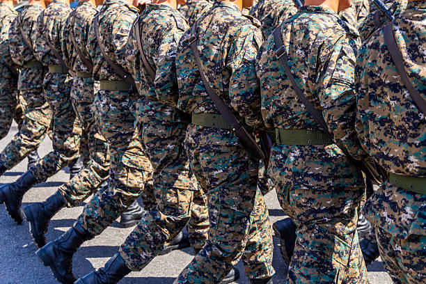 istock Soldiers marching in camouflage uniforms at military parade 2244608453