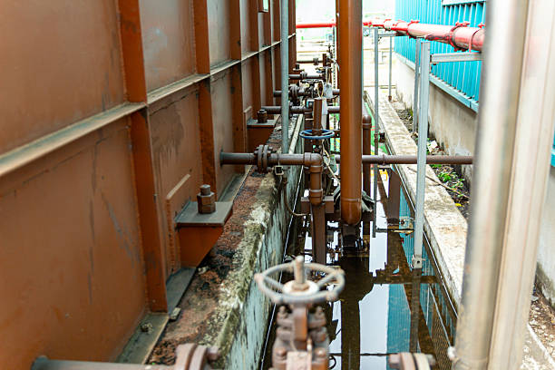 Industrial infrastructure shows complex rusty pipes and weathered metal structure outdoors