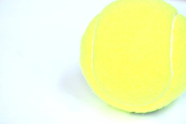 istock yellow tennis ball drop isolated on white background 2244613690