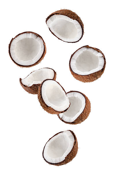 istock Beautifully retouched coconut halves falling through space. Isolated on white. 2244615337