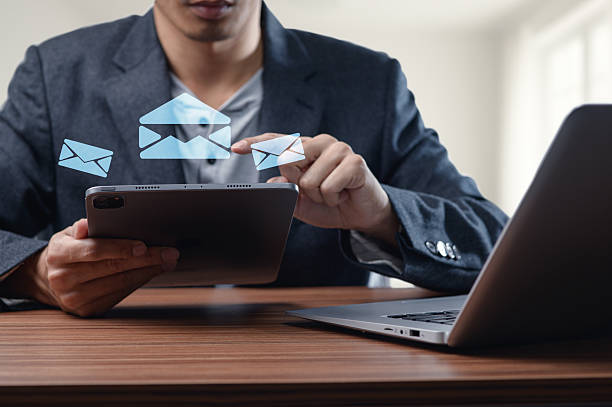 istock Businessman Using Tablet to Send and Receive Emails in Office Setting 2244616529