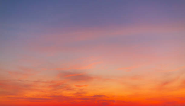 istock Clouds and sky backdrop at sunrise and sunset,Sunrise background. Dramatic majestic scenery sunset. Sky with clouds in Sunrise sky light background. Sunrise with clouds in various shapes. Calm Sunrise sky and sun through clouds over. 2244618005