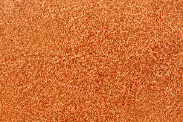 istock Close-up macro of orange leather texture,Artificial textured leather background synthetics closeup macro. 2244618022