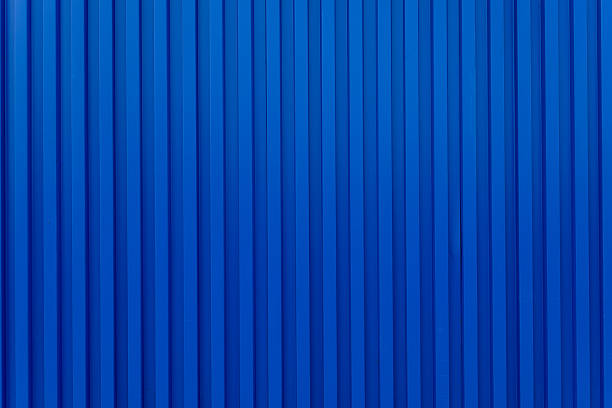istock Blue building wall zinc backdrop,Blue shipping container wall. Seamless vertical metal panel texture with embossed ridges and industrial design. Cargo container backdrop. Realistic vector illustration. 2244618203