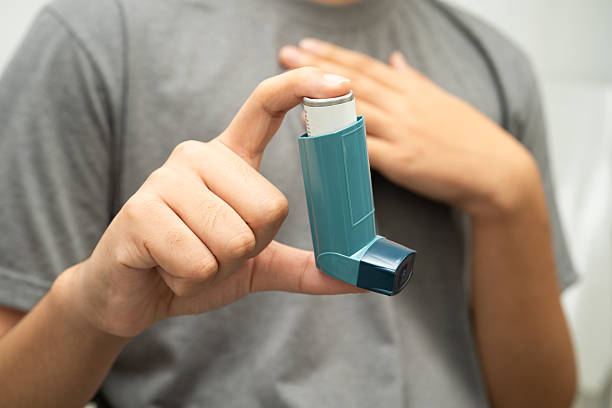 istock Asthma and chronic obstructive pulmonary disease COPD, Asian young man using metered dose inhaler MDI. 2244620590