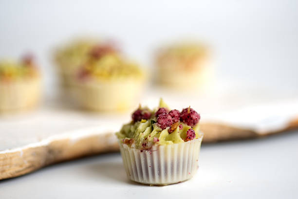 A beautifully decorated dessert cupcake featuring pistachio and intricate toppings and sweet decorations, perfect for celebrations, showcasing the art of dessert making and appealing visuals for culinary enthusiasts.