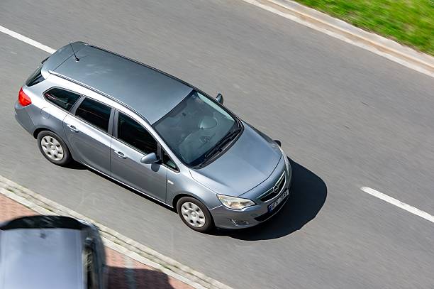 Ostrava, Czechia - June 6, 2025: Opel Astra J Caravan station wagon car with motion blur effect