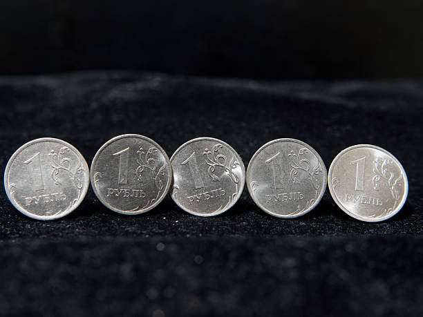 istock Russian One Ruble Coins Stacked on Dark Background 2244628835