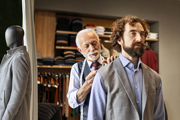istock Fashion Designer Measuring Client’s Jacket in Studio 2244630582