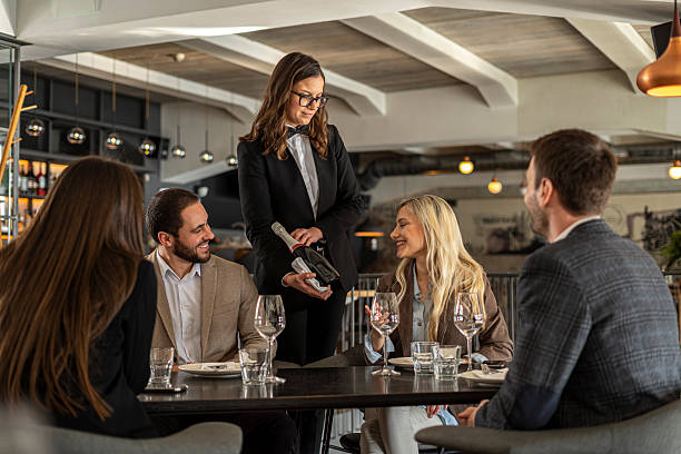 istock Sommelier presenting wine to friends at restaurant 2244632140