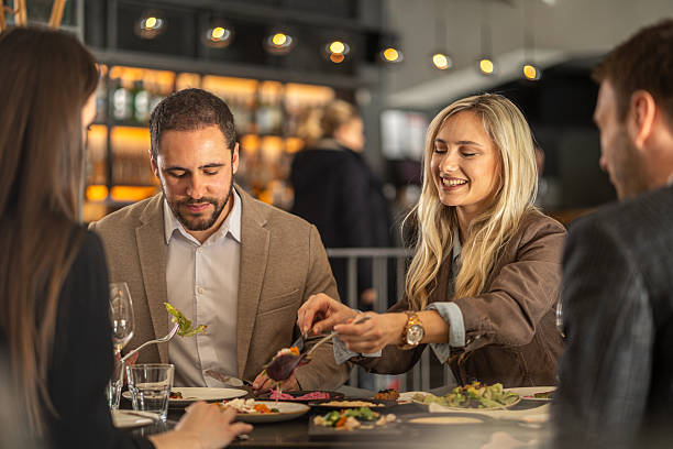 istock Friends sharing dinner, enjoying meal at restaurant 2244632332