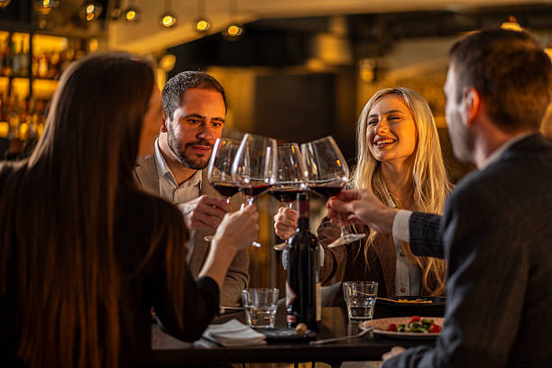 istock Friends toasting red wine celebrating reunion in restaurant 2244633046