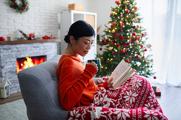 istock Woman spending a peaceful holiday evening reading by the fireplace 2244635439