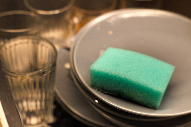 Washing dirty dishes in the kitchen after a party.