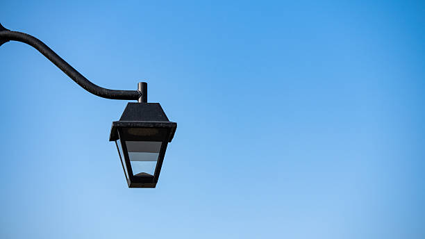 istock Vintage street lamp against blue sky 2244636548