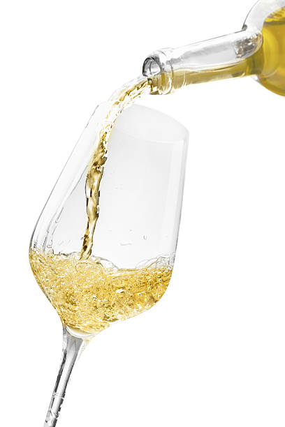 istock Pouring wine into glass isolated on white 2244640003