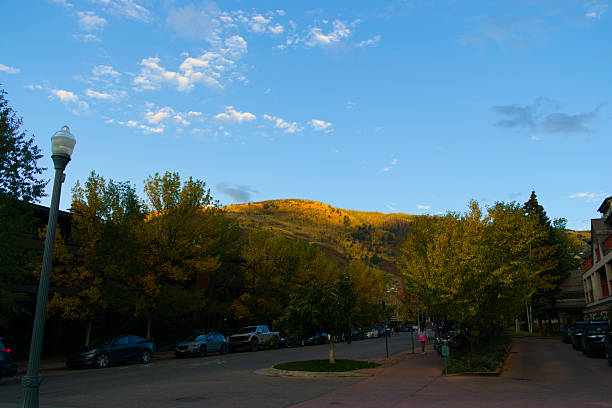 Aspen, Colorado, USA, Sept 28, 2024: Landscape, Aspen tranquil downtown district cityscape, mountains with colorful fall foliage on the background.