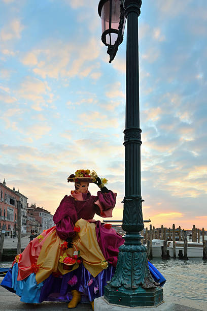 Venice. Italy. 1st of March 2025.Beautiful costumed person stading in Venice near the Bridge of Sighs - & the Doge Palace.  The Carnival is an annual public event - where people travel from all over to participate, photograph or just enjoy the beauty.