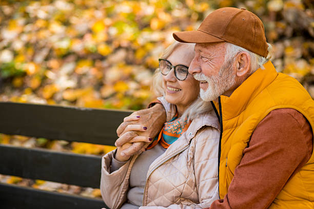 istock Senior couple relaxing on park bench 2244640266