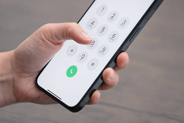 istock Woman dialing number on smartphone against blurred background, closeup 2244641571