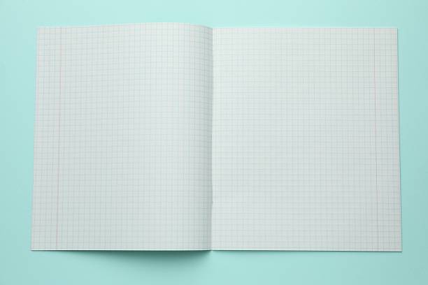 Open copybook with checkered sheets of paper on light blue background, top view. School stationery