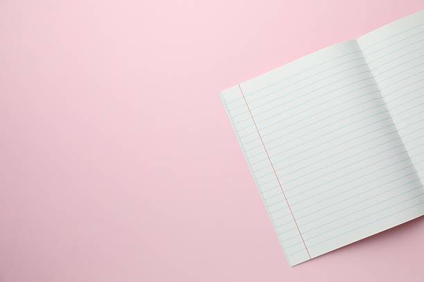 istock Open copybook on pink background, top view. School stationery 2244642529