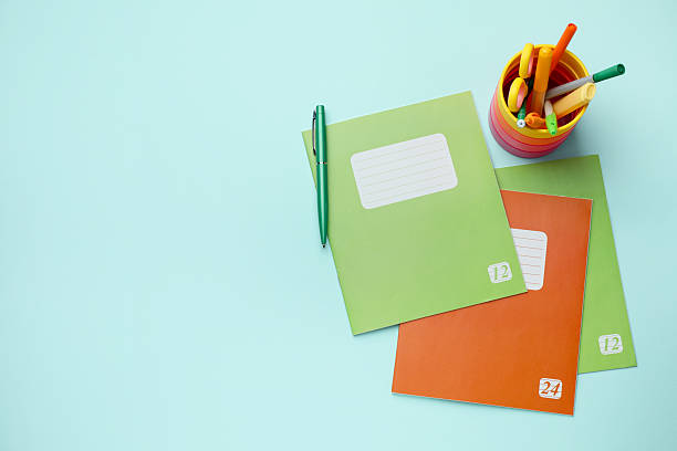 istock Copybooks and other school stationery on light blue background, flat lay. Space for text 2244642553