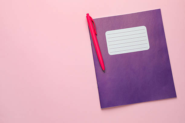 istock Copybooks and pen on pink background, top view. Space for text 2244642671