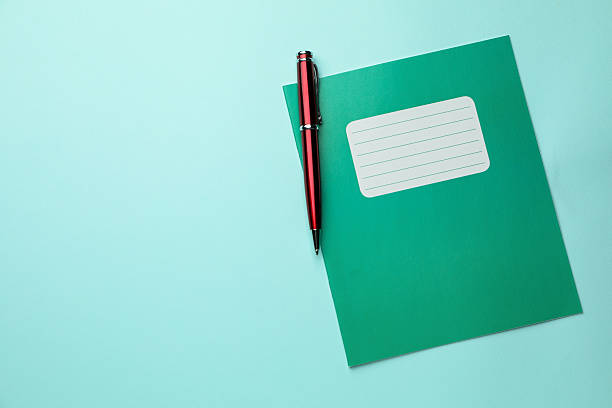 istock Copybook and pen on light blue background, top view. School stationery 2244642728