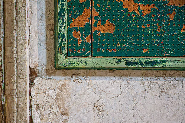Closeup old weathered wooden windows with blue glass on abandoned building, full frame horizontal composition