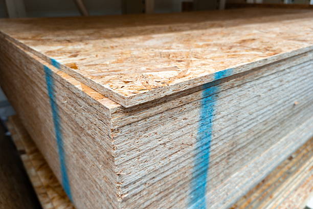 istock Sheets of oriented strand board stacked in a workshop, showcasing details of the material's texture and finish 2244645986