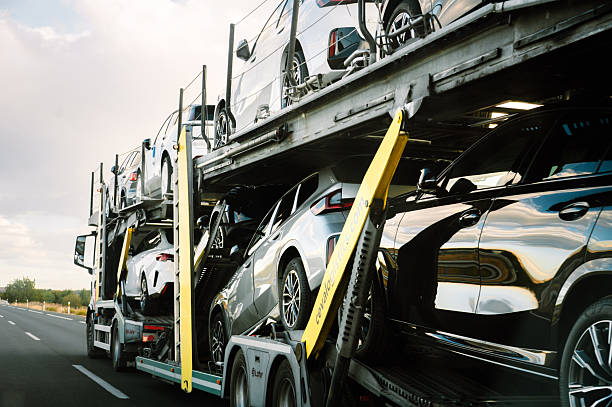 La Rioja, Spain - 21 October, 2025: A semi truck on a highway transporting brand new BMW cars