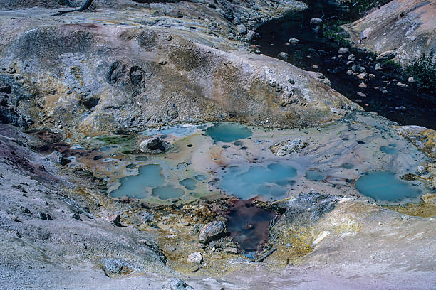 Hot Springs about 7 mi  southeast of Lassen Peak is Devils Kitchen. In this geothermal area the hot springs are so acidic that they have eaten pits and holes in the bedrock. Lassen Volcanic National Park, California.Cascade Range.