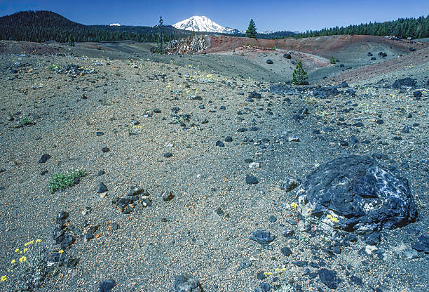 Volcanic bombs are molten or semi-molten rock ejected from a volcano that solidifies in flight, taking on various shapes like spindle, bread crust, or cannonball. They range in size from small fragments to large, heavy boulders.  Lassen Volcanic National Park, California.Cascade Range.