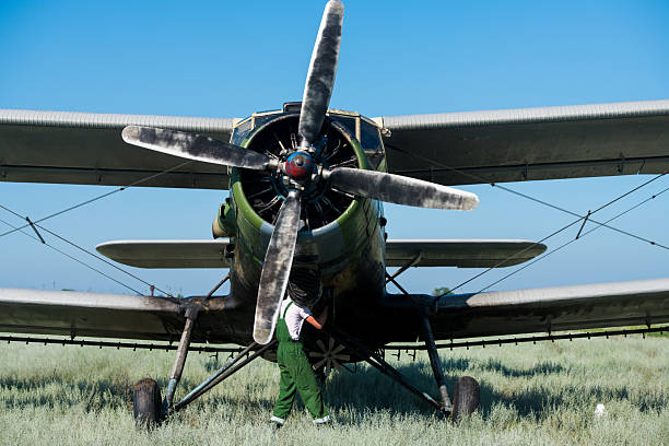 An aviation technician prepares an agricultural aviation aircraft for the next flight and checks the serviceability of all aircraft systems