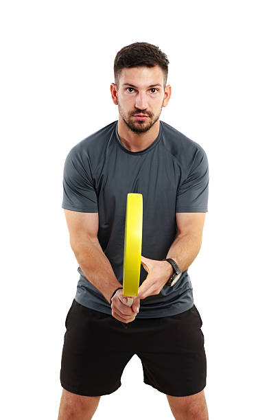 istock Man practicing with a yellow fitness circle in a bright indoor space 2244657633