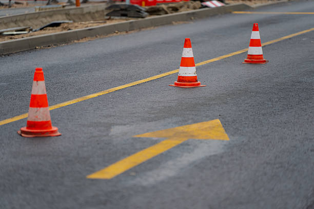 istock Yellow directional arrow and orange cones marking roadway in city work zone representing public safety management, transport planning, and infrastructure development process concept 2244658002