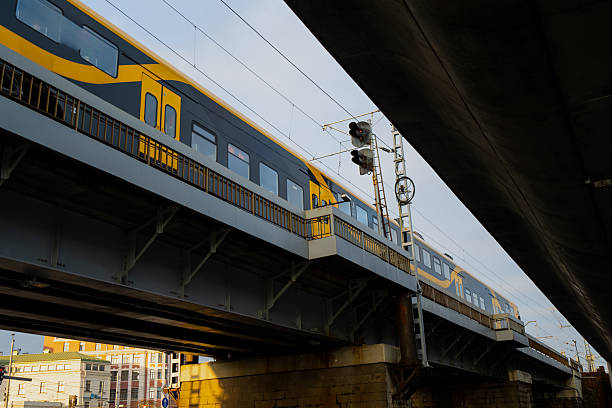 istock Passenger train on steel railway bridge in Riga highlighting transport infrastructure, electric lines, and structural design representing Latvia's modernized rail connection and urban mobility system 2244658179