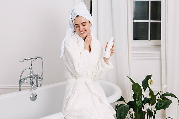 istock Young woman enjoying skincare routine in modern bathroom setting 2244658339