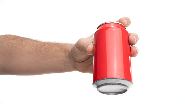 istock Hand holding a red soda can in a bright setting for a refreshing drink experience 2244659888