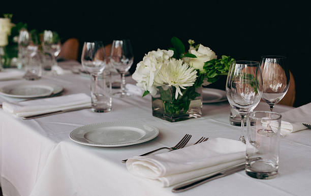 istock Elegant Table Setting With White Flowers, Glassware, And Silverware For A Formal Dinner Event 2244660802
