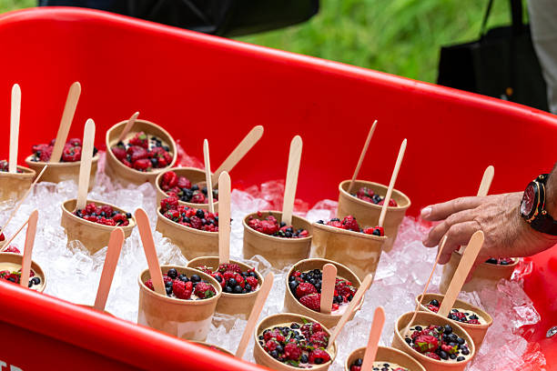 Cold Berry Cups With Raspberries And Blackberries In Paper Cups On Ice In A Red Tub