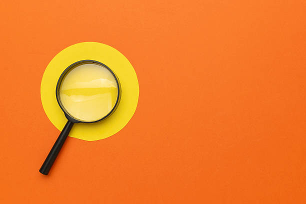 istock Magnifying Glass on Orange and Yellow Minimalist Background for Exploration and Discovery Concepts 2244661932