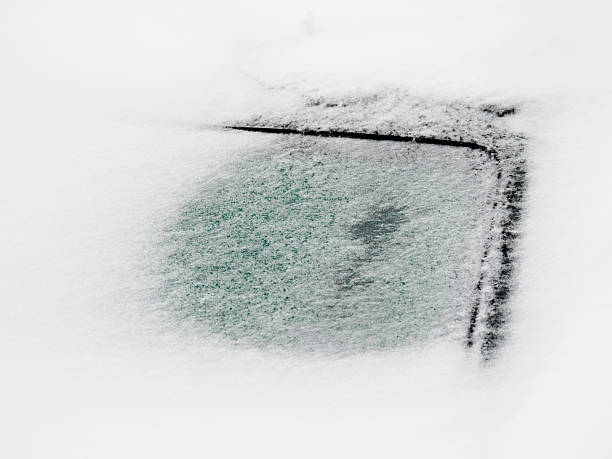 istock Heavy snow covers a parked car in a wintry landscape 2244662252