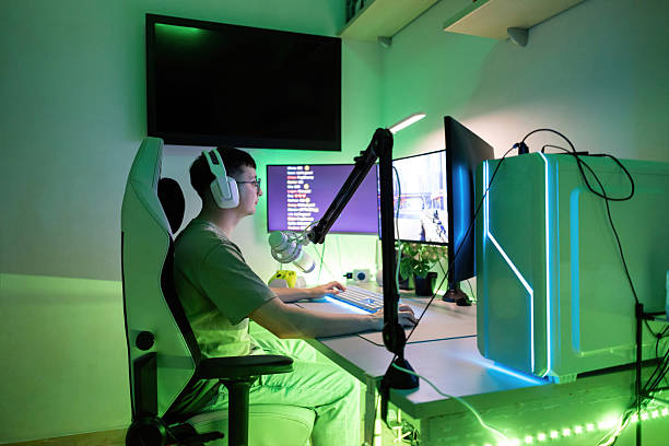 istock Gamer playing computer game, wearing headphones, and using a microphone. Live streaming esports content at night 2244662454