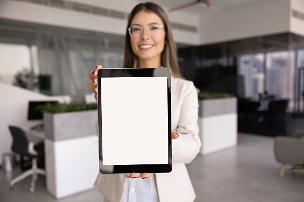 istock Happy young businesswoman showing tablet blank screen 2244666761