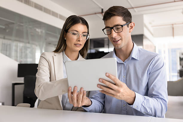 istock Serious Latin female professional advisor woman explaining electronic document 2244668210