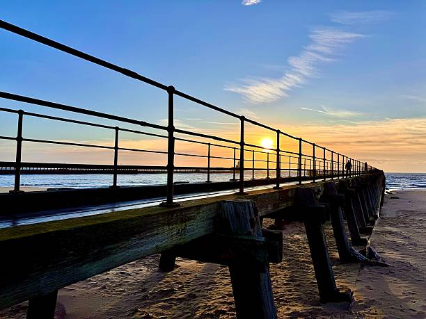 istock Sunrise coloured cloudscape against Blyth pier in Northumberland 2244668309